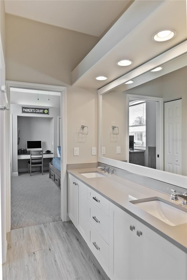 bathroom with hardwood / wood-style floors and vanity