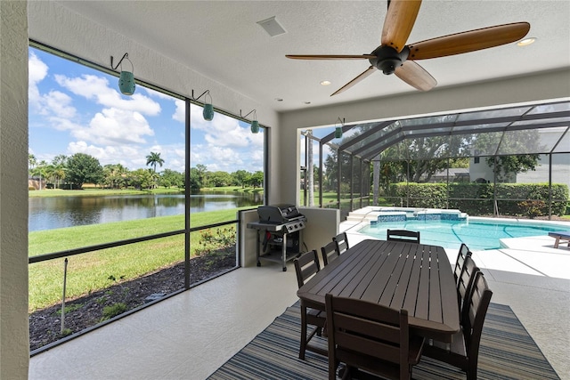 sunroom / solarium with ceiling fan, a water view, and a swimming pool