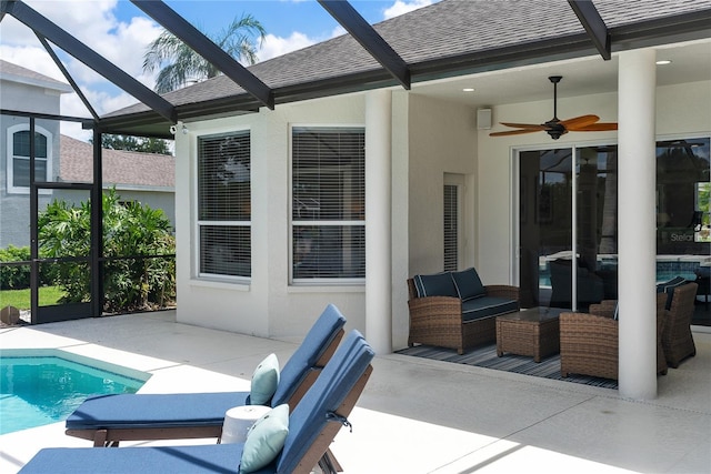 view of patio featuring outdoor lounge area, glass enclosure, and ceiling fan