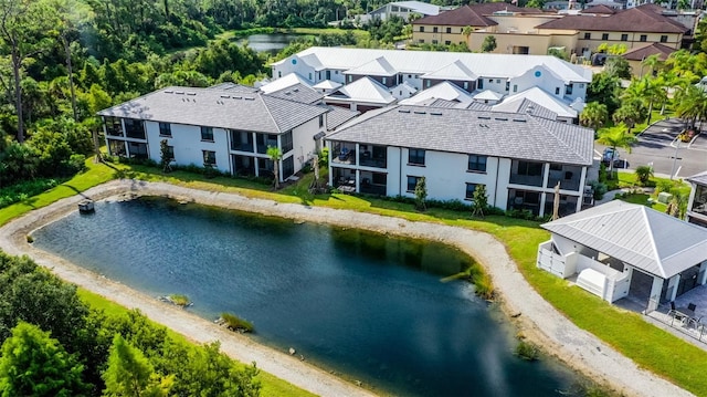 aerial view of residential area featuring a large body of water