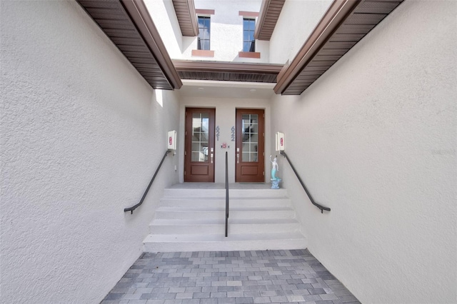 view of exterior entry with stucco siding
