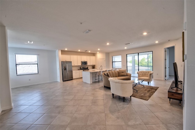 tiled living room featuring a wealth of natural light