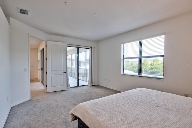 bedroom featuring access to outside, light colored carpet, and baseboards