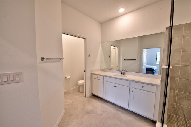bathroom featuring vanity, toilet, tile patterned floors, ensuite bath, and baseboards