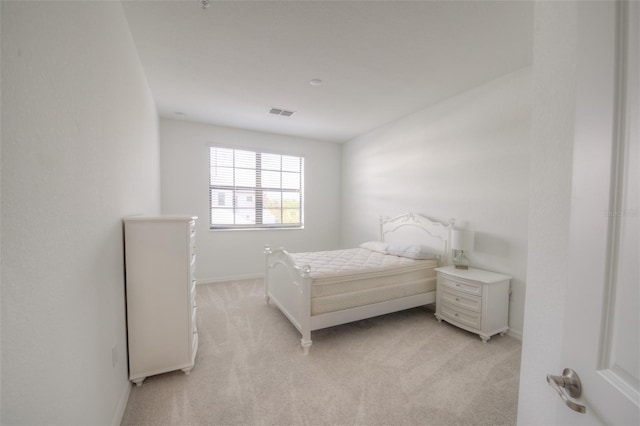 bedroom featuring light colored carpet and baseboards