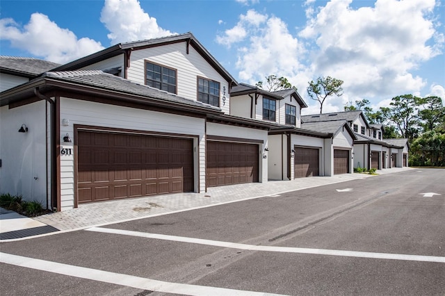 view of side of home featuring a garage and driveway