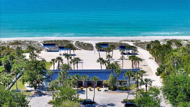 bird's eye view with a water view and a beach view