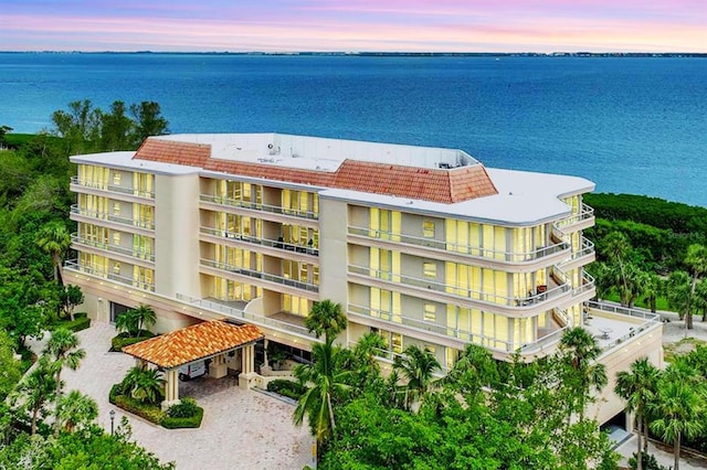 3080 Grand Bay Blvd Unit 532, Longboat Key, FL 34228 - property at dusk with a water view, driveway, and a view of apartment building / complex