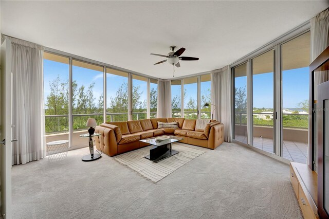 3080 Grand Bay Blvd Unit 532, Longboat Key, FL 34228 - carpeted living room with a ceiling fan, plenty of natural light, and a wall of windows