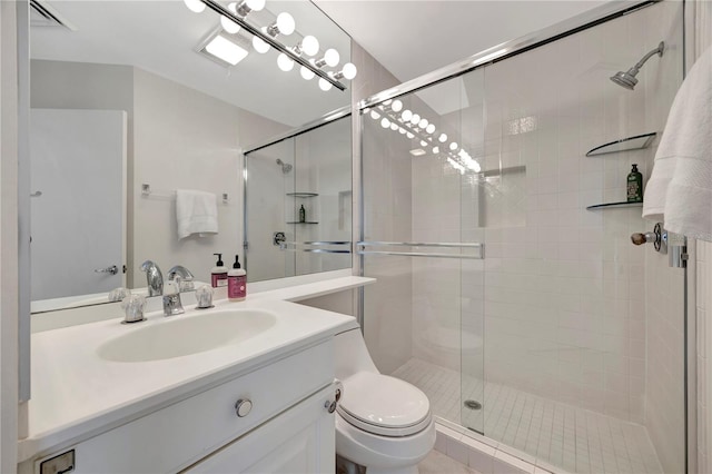 bathroom featuring vanity, toilet, and an enclosed shower