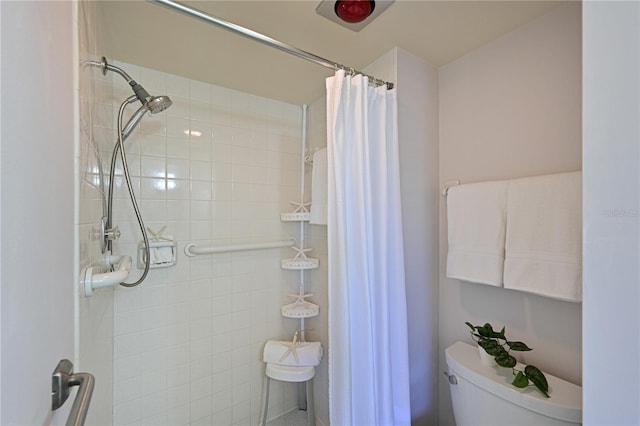 bathroom with a shower with curtain and toilet