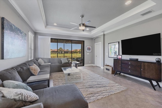 tiled living room with a raised ceiling and a healthy amount of sunlight