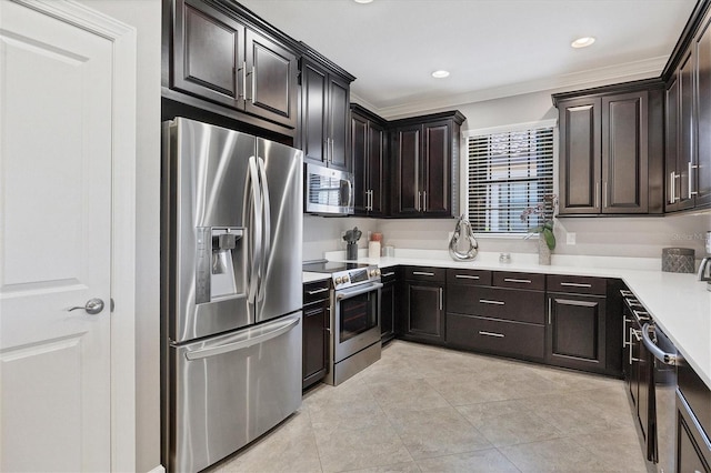 kitchen with appliances with stainless steel finishes, dark brown cabinets, and light tile patterned flooring