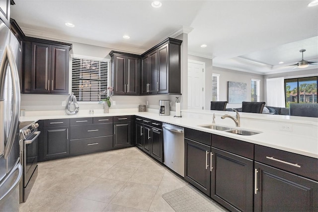 kitchen featuring light tile patterned floors, appliances with stainless steel finishes, sink, ceiling fan, and dark brown cabinetry