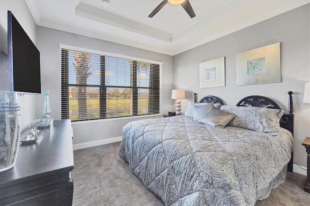 bedroom featuring a tray ceiling, ceiling fan, carpet, and ornamental molding