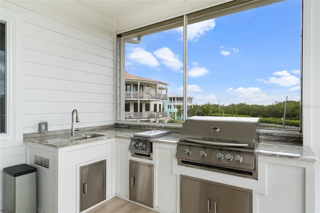 view of patio featuring grilling area, sink, and an outdoor kitchen