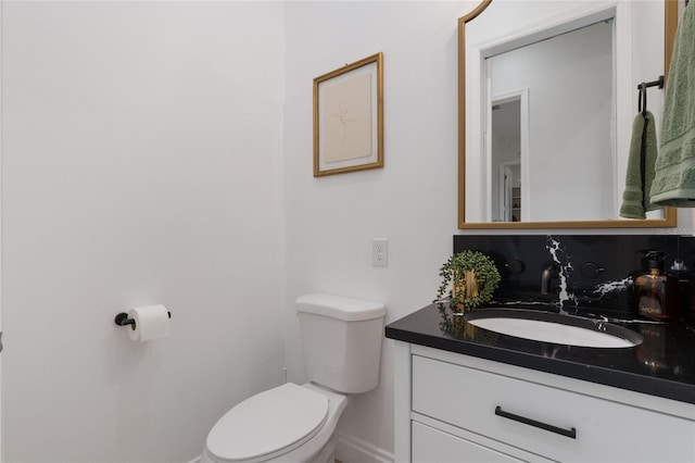 bathroom featuring tasteful backsplash, vanity, and toilet