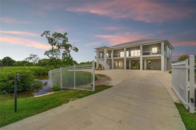 view of front of house featuring a carport and a balcony