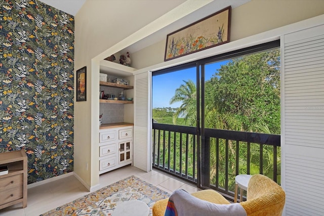 living area with a wealth of natural light and light tile patterned flooring