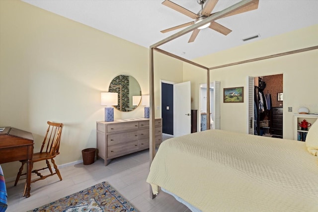 bedroom with light wood-type flooring, a closet, a spacious closet, and ceiling fan