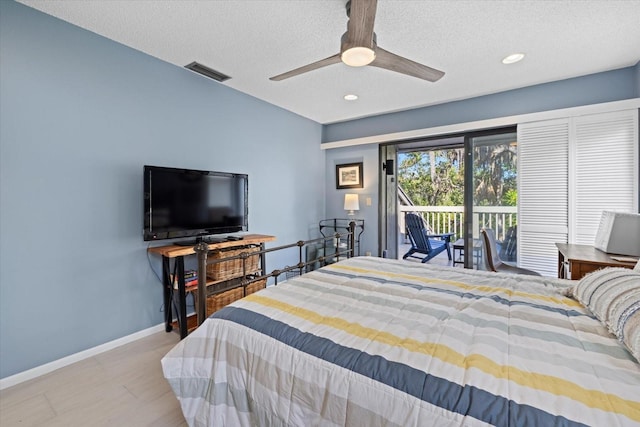 bedroom featuring a textured ceiling, access to outside, and ceiling fan