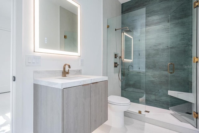 bathroom featuring vanity, walk in shower, and toilet