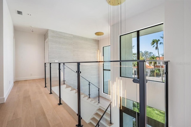 corridor with light hardwood / wood-style floors