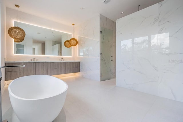 bathroom with vanity, plus walk in shower, tile walls, and tile patterned flooring