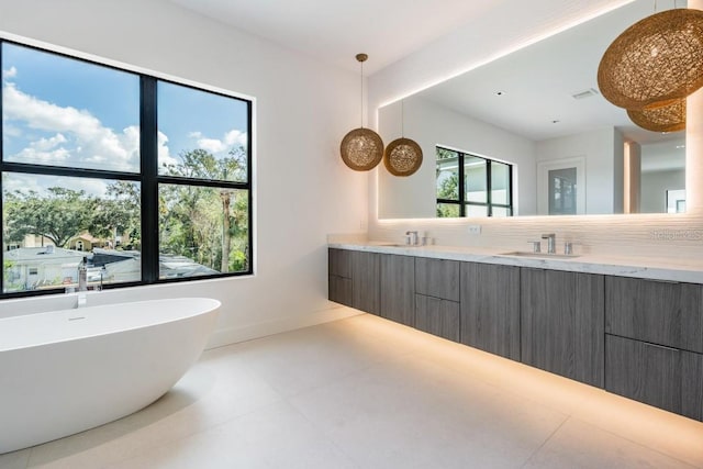 bathroom with vanity, a bathtub, and backsplash