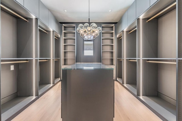 walk in closet with a chandelier