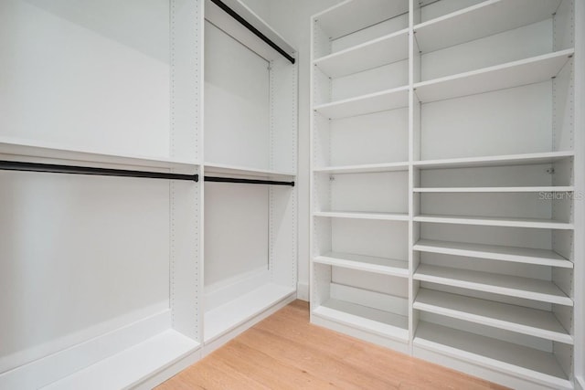 spacious closet featuring hardwood / wood-style flooring