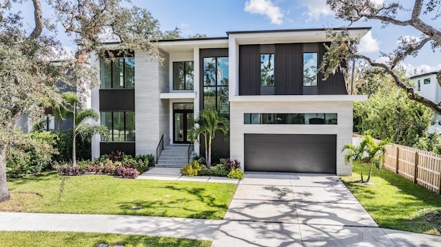 contemporary home featuring a front yard and a garage