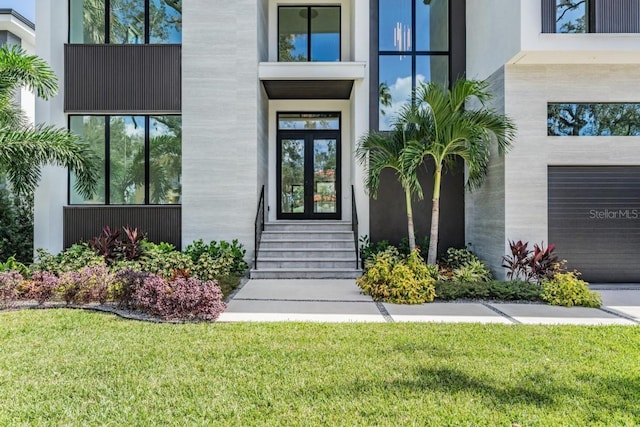 entrance to property with a yard and a garage