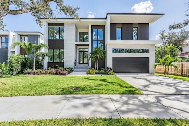 contemporary house with a garage and a front lawn