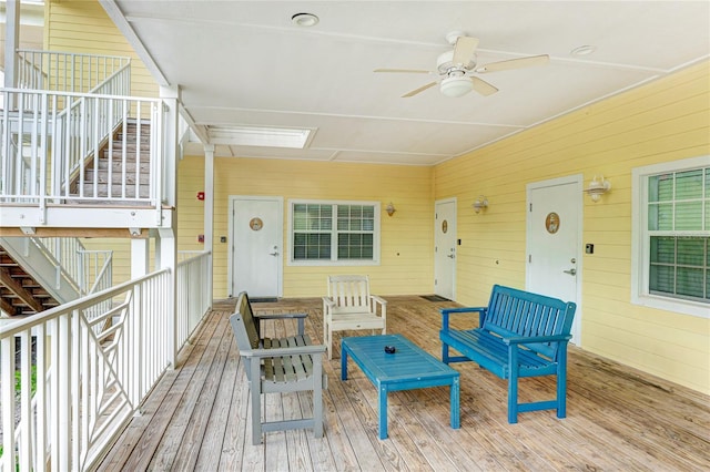 wooden deck with an outdoor living space and ceiling fan