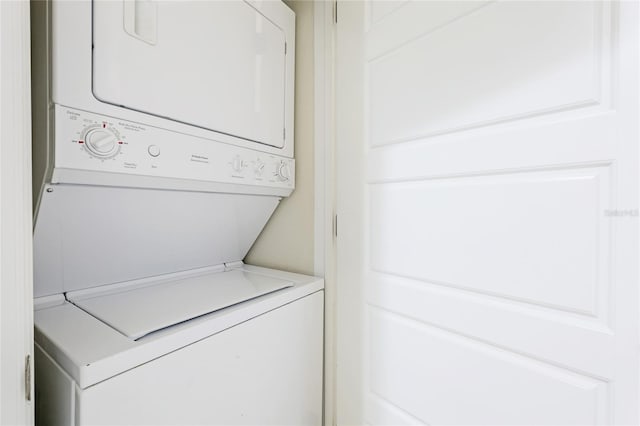 laundry area featuring stacked washer / drying machine