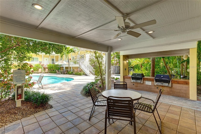 view of patio / terrace featuring exterior kitchen, ceiling fan, and area for grilling