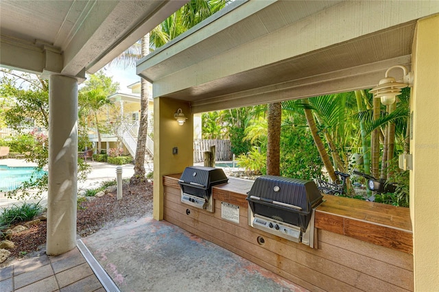 view of patio / terrace featuring an outdoor kitchen and a grill