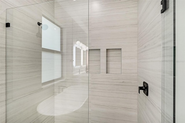 full bath featuring a marble finish shower