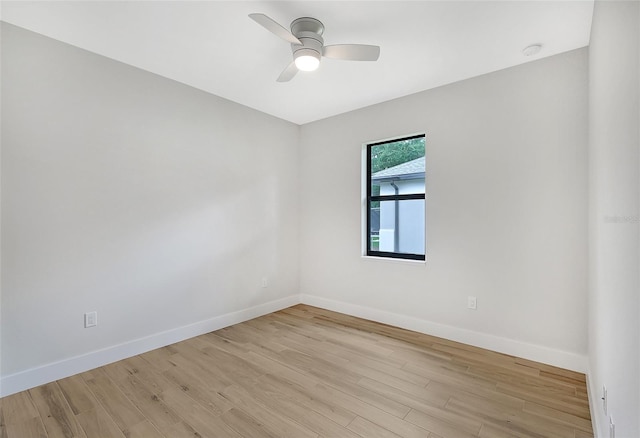 unfurnished room featuring ceiling fan, light wood-type flooring, and baseboards