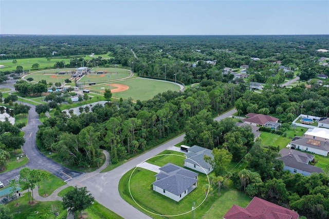 birds eye view of property with a forest view