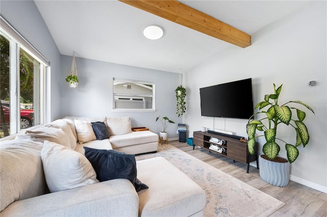 living room featuring lofted ceiling with beams and light hardwood / wood-style flooring