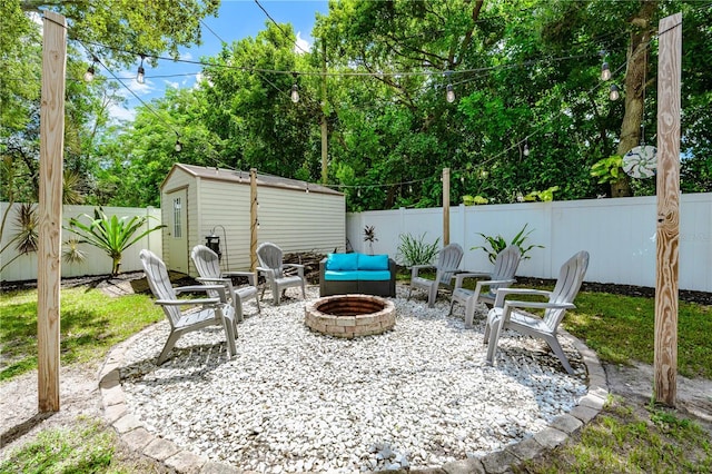 view of patio / terrace with a storage unit and a fire pit