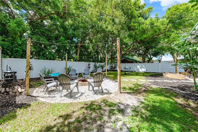 view of yard featuring an outdoor fire pit