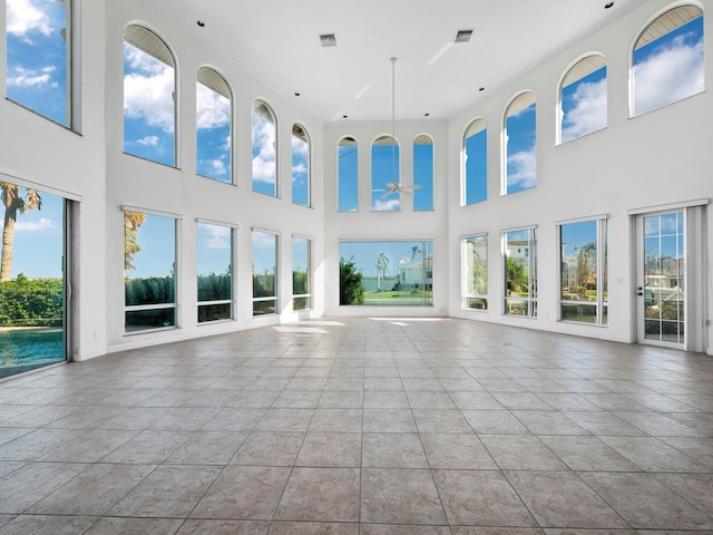 unfurnished sunroom featuring ceiling fan