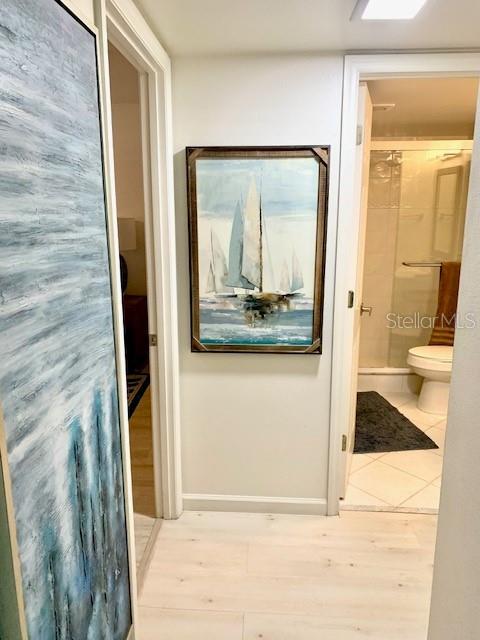 8630 Midnight Pass Rd Unit 103A, Sarasota, FL 34242 - corridor with baseboards and tile patterned flooring