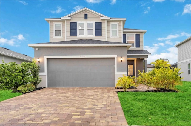 view of front facade with a front lawn and a garage