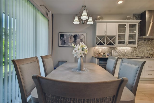 tiled dining room featuring a notable chandelier