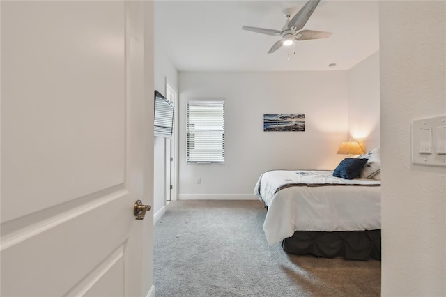 bedroom featuring ceiling fan and light carpet