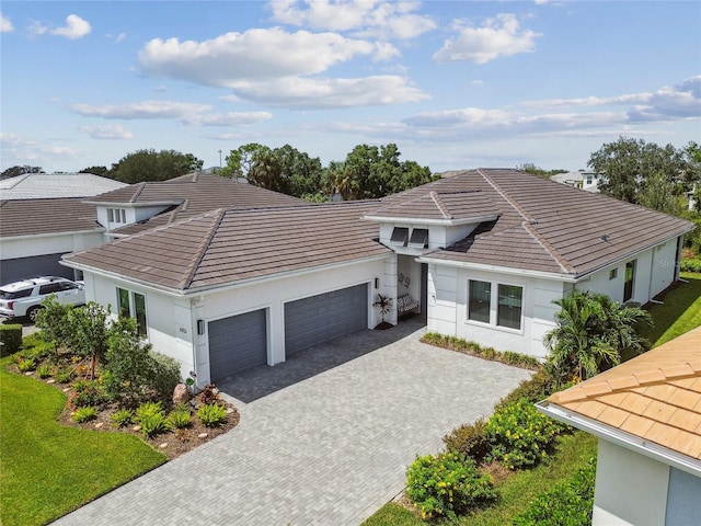 4952 Surfside Cir, Bradenton, FL 34211 - view of front of property with an attached garage, decorative driveway, stucco siding, and a tiled roof